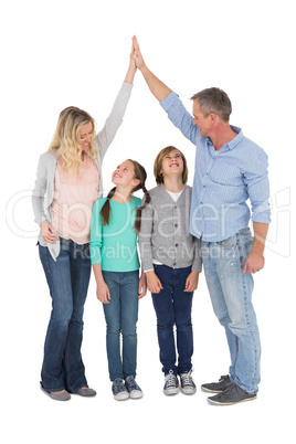 Unified couple high fiving each other with their child below