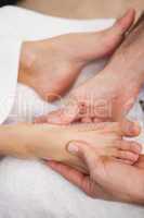 Pedicurist massaging a customers foot