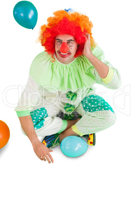 Funny clown sitting on floor