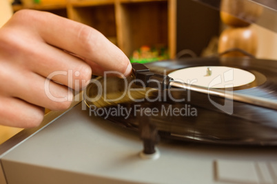 Young man putting on a vinyl