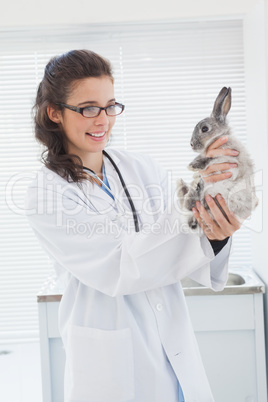 Happy vet petting a cut bunny