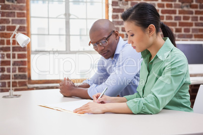 Casual business team working together at desk