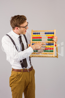 Geeky businessman using an abacus