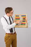 Geeky businessman using an abacus