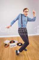 Geeky hipster dancing to vinyl