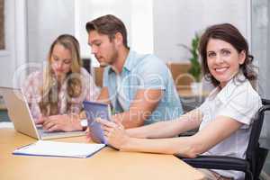 Business people using digital tablet and laptop in meeting