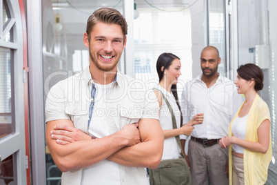 Smiling businessman posing with arms folded