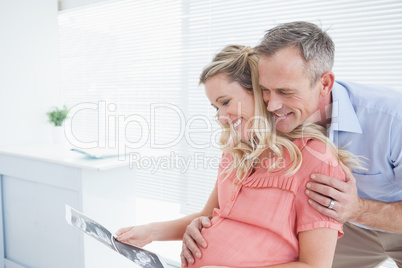 Happy couple looking at ultrasound