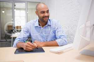 Man working at desk with computer and digitizer