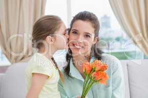 Cute girl giving flowers to mother