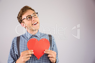 Geeky hipster holding a heart card Geeky hipster holding a heart card