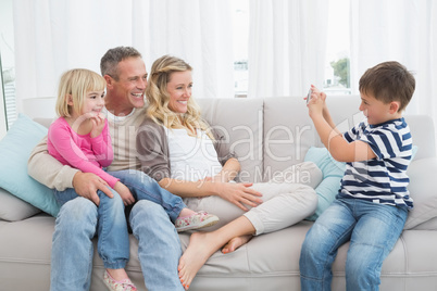 Son taking a photo of his family