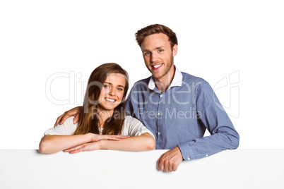 Happy young couple with blank board Happy young couple with blank board