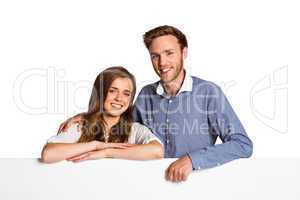 Happy young couple with blank board