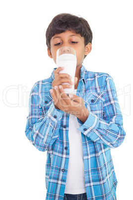 Cute boy drinking glass of milk
