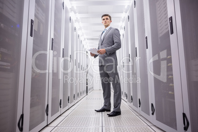 Young technician in suit standing