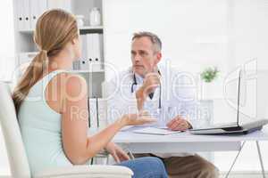 Concerned doctor talking to his patient