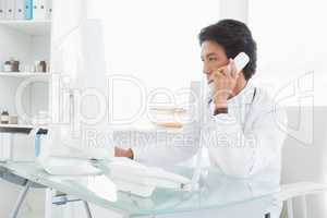 Doctor making work phone calls