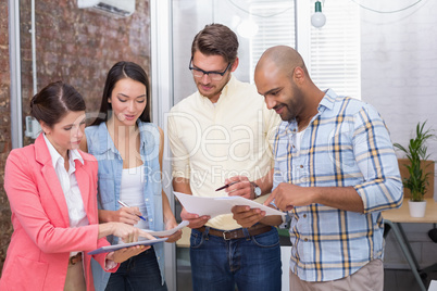 Business people looking at tablet pc and holding paperwork