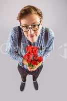 Geeky hipster holding a bunch of roses