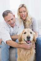 Attractive couple enjoying their dogs company