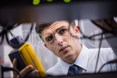 Technician using digital cable analyzer on server