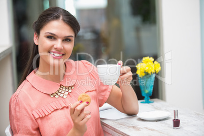 Pretty brunette having a coffee