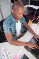 Casual businessman working on laptop at desk