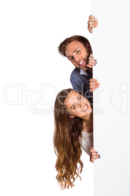 Happy young couple with blank board