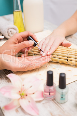 Nail technician giving customer a manicure