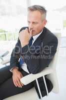 Worried businessman sitting at work