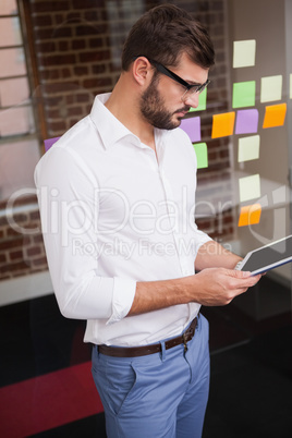 Casual businessman using his tablet Casual businessman using his tablet