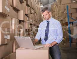 Concentrated warehouse manager using laptop