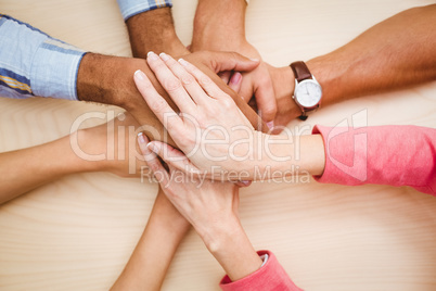 Business people putting their hands together on the table Business people putting their hands together on the table