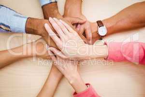 Business people putting their hands together on the table