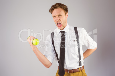 Geeky businessman lifting a dumbbell