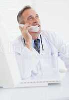 Smiling doctor answering a call