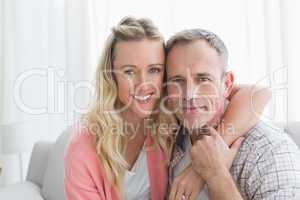 Portrait of a loving couple sitting on couch