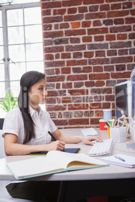 Casual designer working at her desk