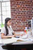 Casual designer working at her desk