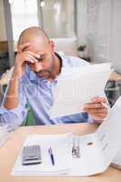 Businessman with paperwork at desk