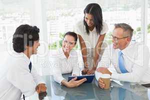 Business team looking at a tablet