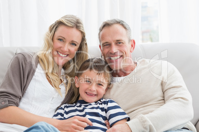 Parent cuddling their son on the couch