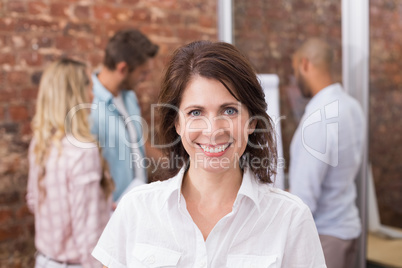 Casual businesswoman smiling at camera during meeting