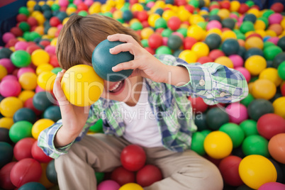 Cute boy smiling in ball pool