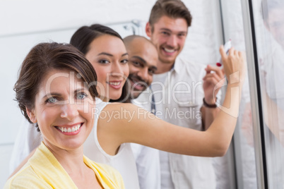 Smiling business people looking at camera during a meeting