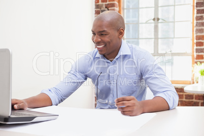 Casual businessman using his laptop at desk