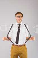 Geeky businessman pulling his suspenders
