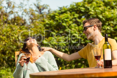 Young couple enjoying red wine