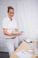 Businesswoman looking at folder in office